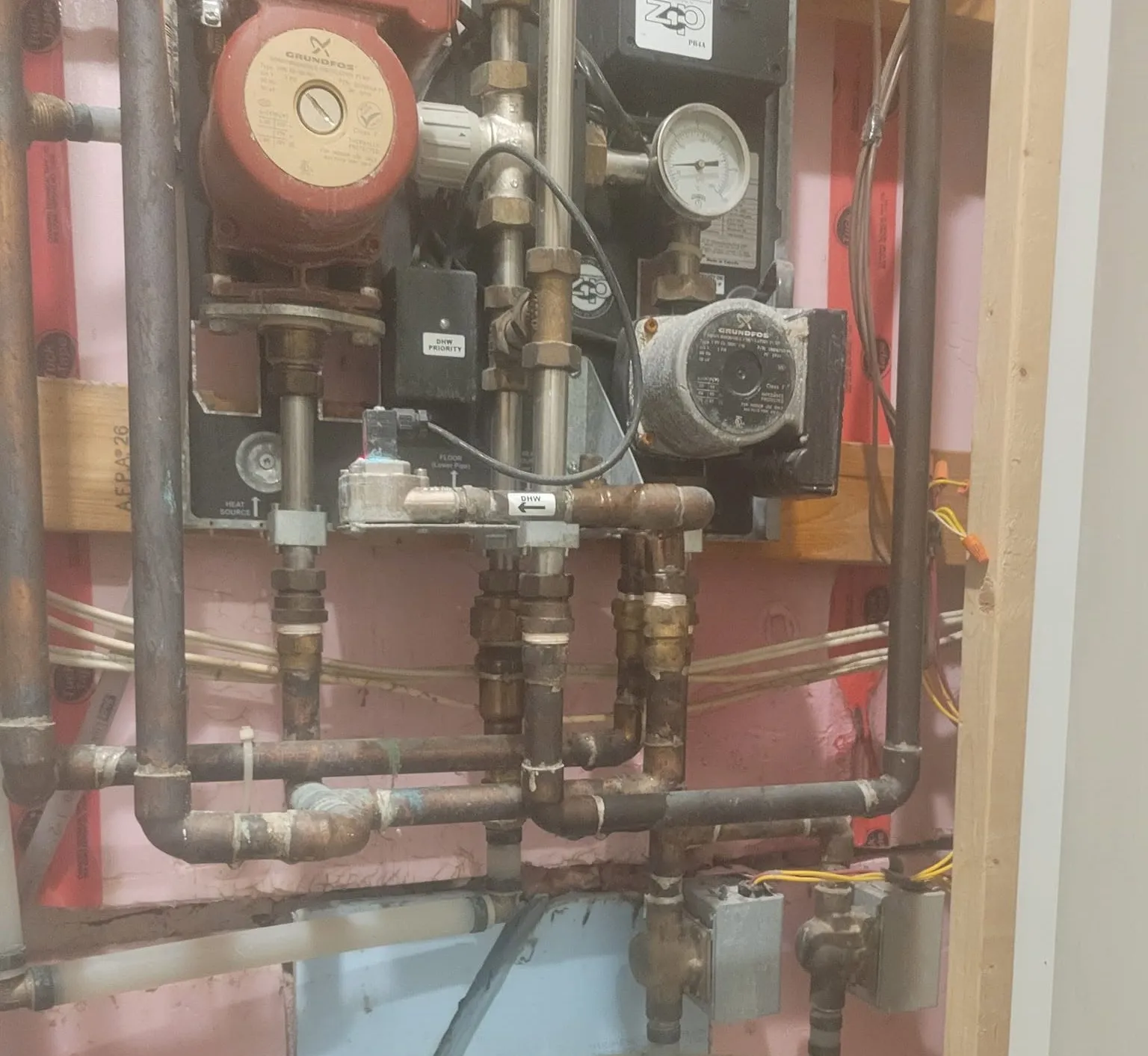 Copper heating manifold with pressure gauges installed by Sabon Plumbing