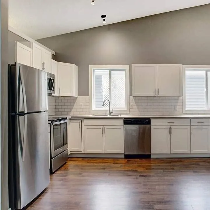 Finished Calgary kitchen with new plumbing, subway tile backsplash and stainless appliances by Sabon Plumbing